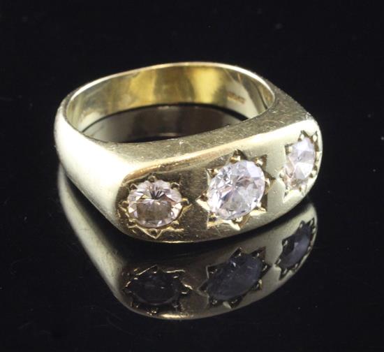 A gentlemans 18ct gold and gypsy set three stone diamond ring, size T.